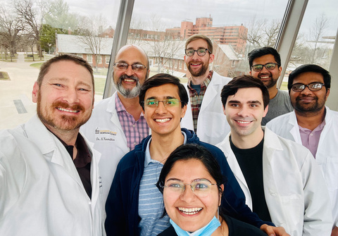 The Karandikar Lab group with the Iowa City VA building in the background.