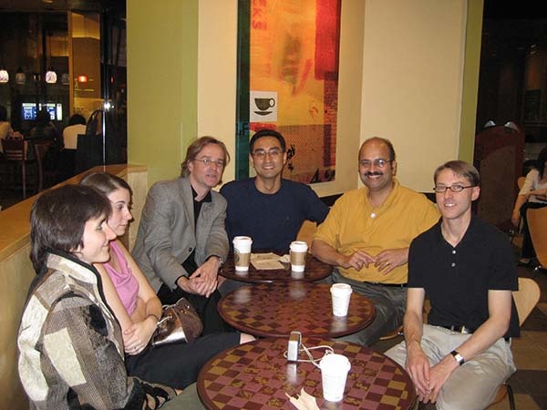 Six people sitting in a cafe