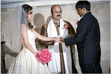 Dr. Karandikar conducting a wedding with a bride and groom in front of him