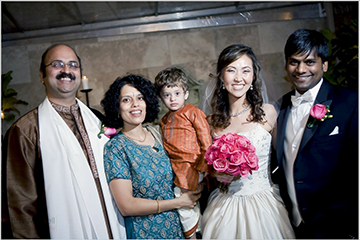 Five people smiling at a wedding