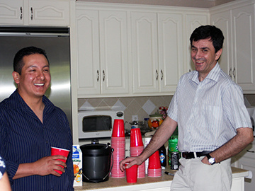 Two people in a kitchen smiling