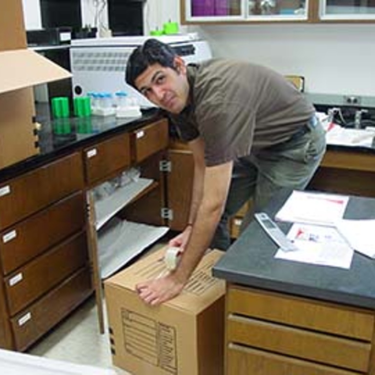 Riyaz taping a box shut