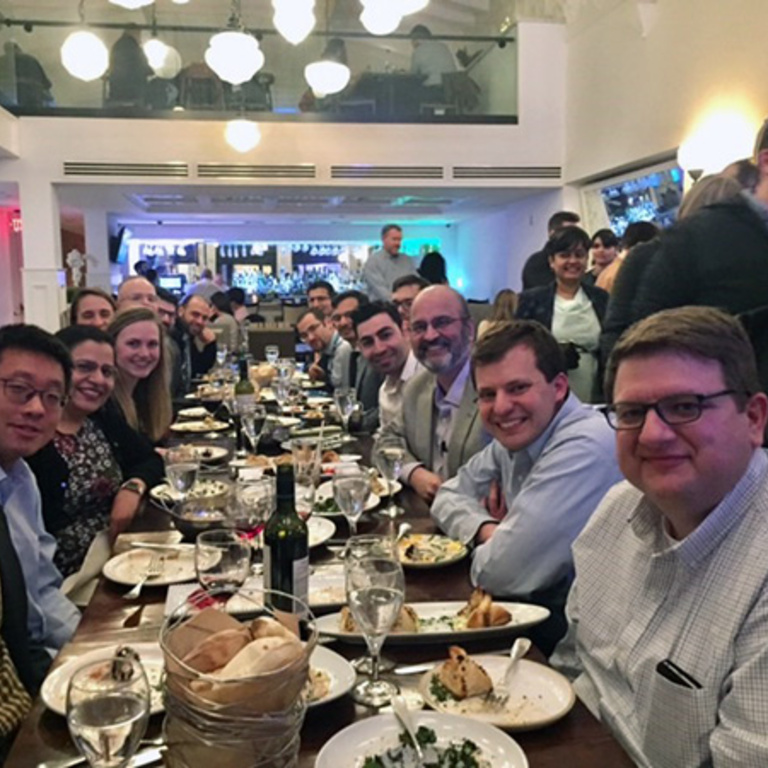 Many people sitting at a restaurant table