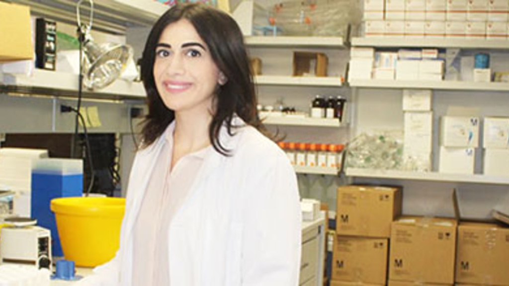 Farah Itani in front of lab equipment