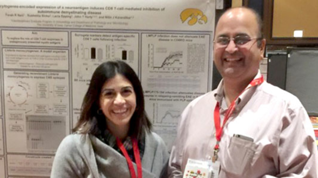 Farah Itani and Dr. Karandikar standing in front of a research poster